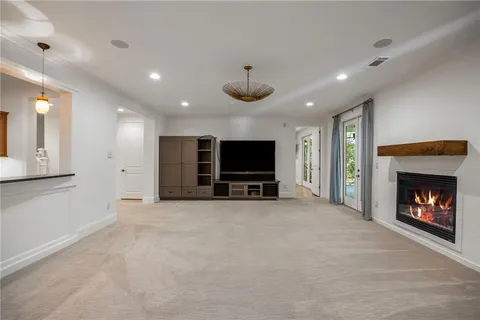 a view of an empty room with a fireplace and a window