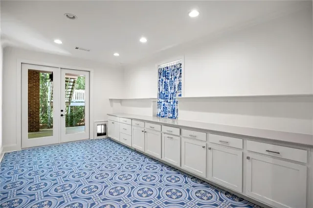 a spacious bathroom with a double vanity sink a mirror and a