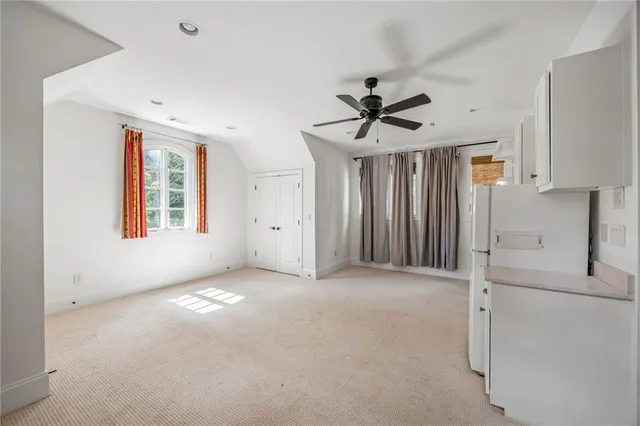 a view of a kitchen with closet and electronic appliances