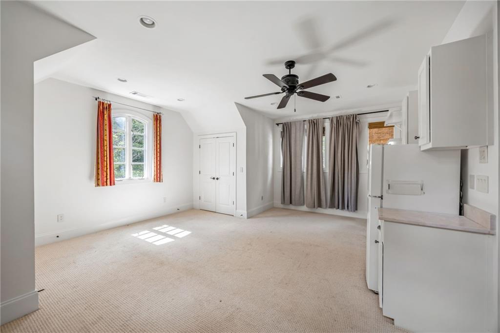 9179 Selborne Lane Chattahoochee Hills, GA 30268 - Photo 40 of 53 a view of a livingroom with a ceiling fan and window