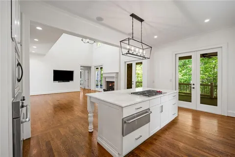 a kitchen with a stove and a chandelier