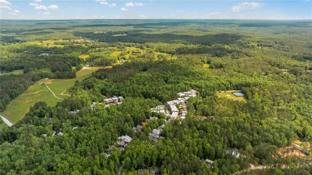 an aerial view of a house with a yard and trees