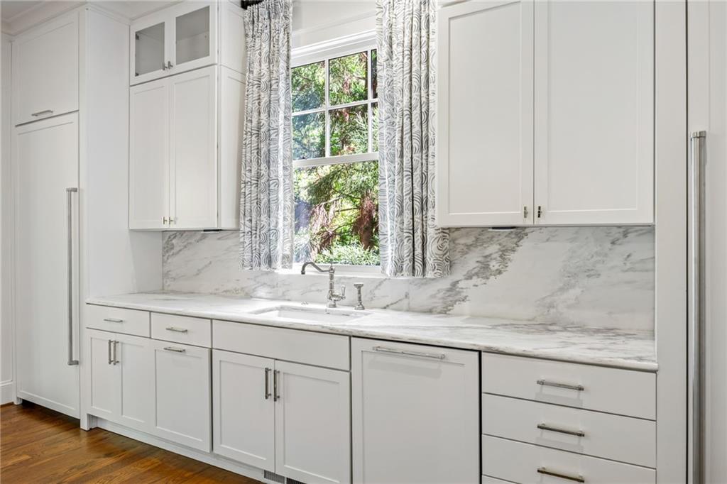 9179 Selborne Lane Chattahoochee Hills, GA 30268 - Photo 5 of 53 a sink with white cabinets and a window