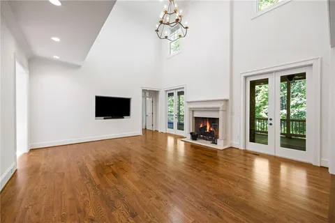 a view of a livingroom with wooden floor and a fireplace
