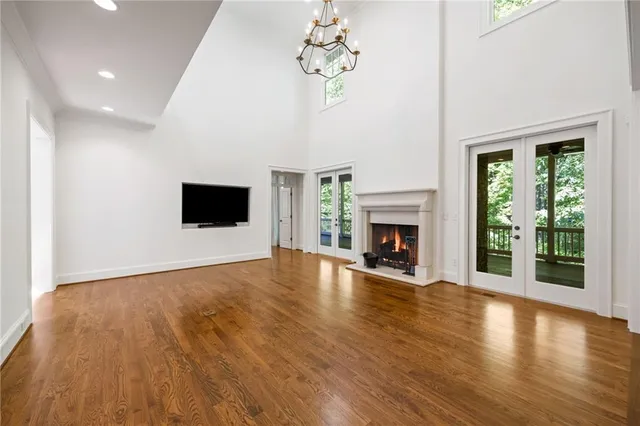 a view of a livingroom with wooden floor and a fireplace