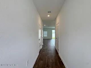 an empty room with a empty space and windows