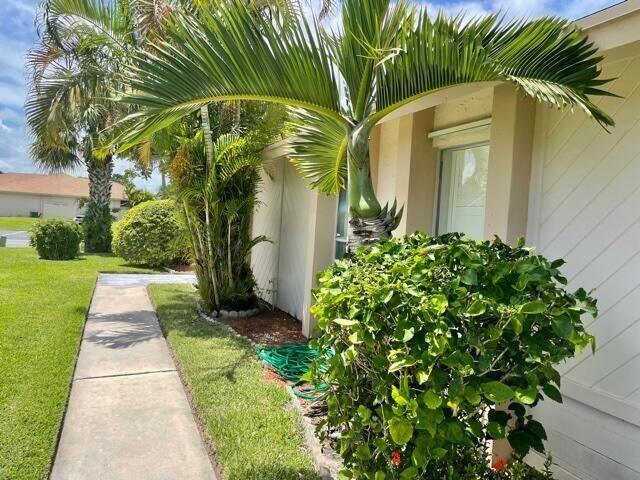 107 Bent Arrow Drive, Unit D Jupiter, FL 33458 - Photo 3 of 15 a view of a yard with plants