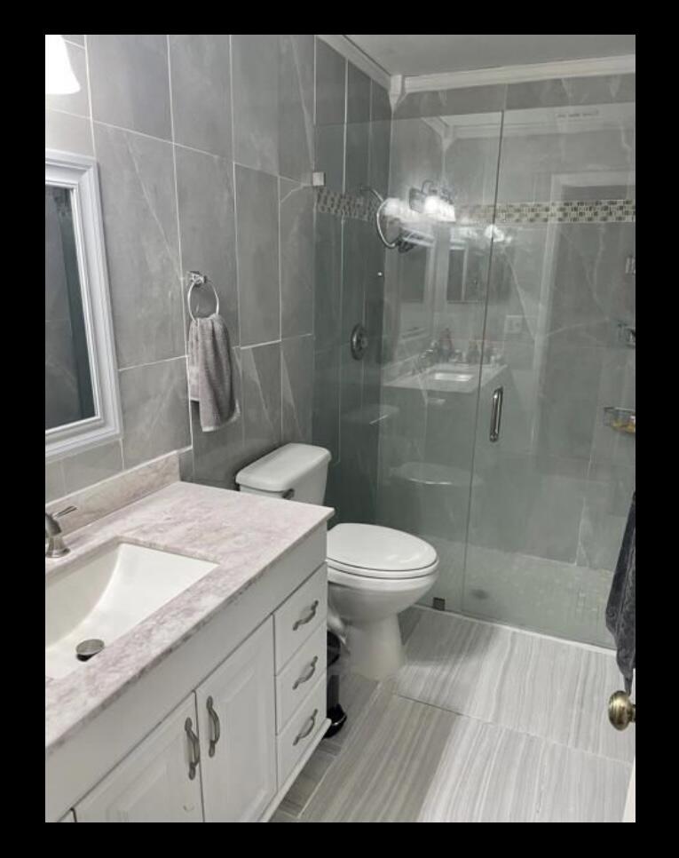 107 Bent Arrow Drive, Unit D Jupiter, FL 33458 - Photo 5 of 15 a bathroom with a sink a toilet and shower