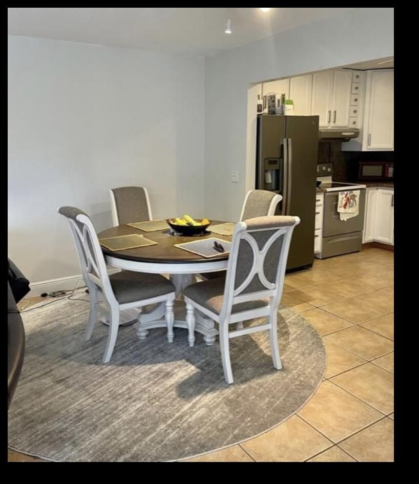 107 Bent Arrow Drive, Unit D Jupiter, FL 33458 - Photo 8 of 15 a view of a dining room with furniture