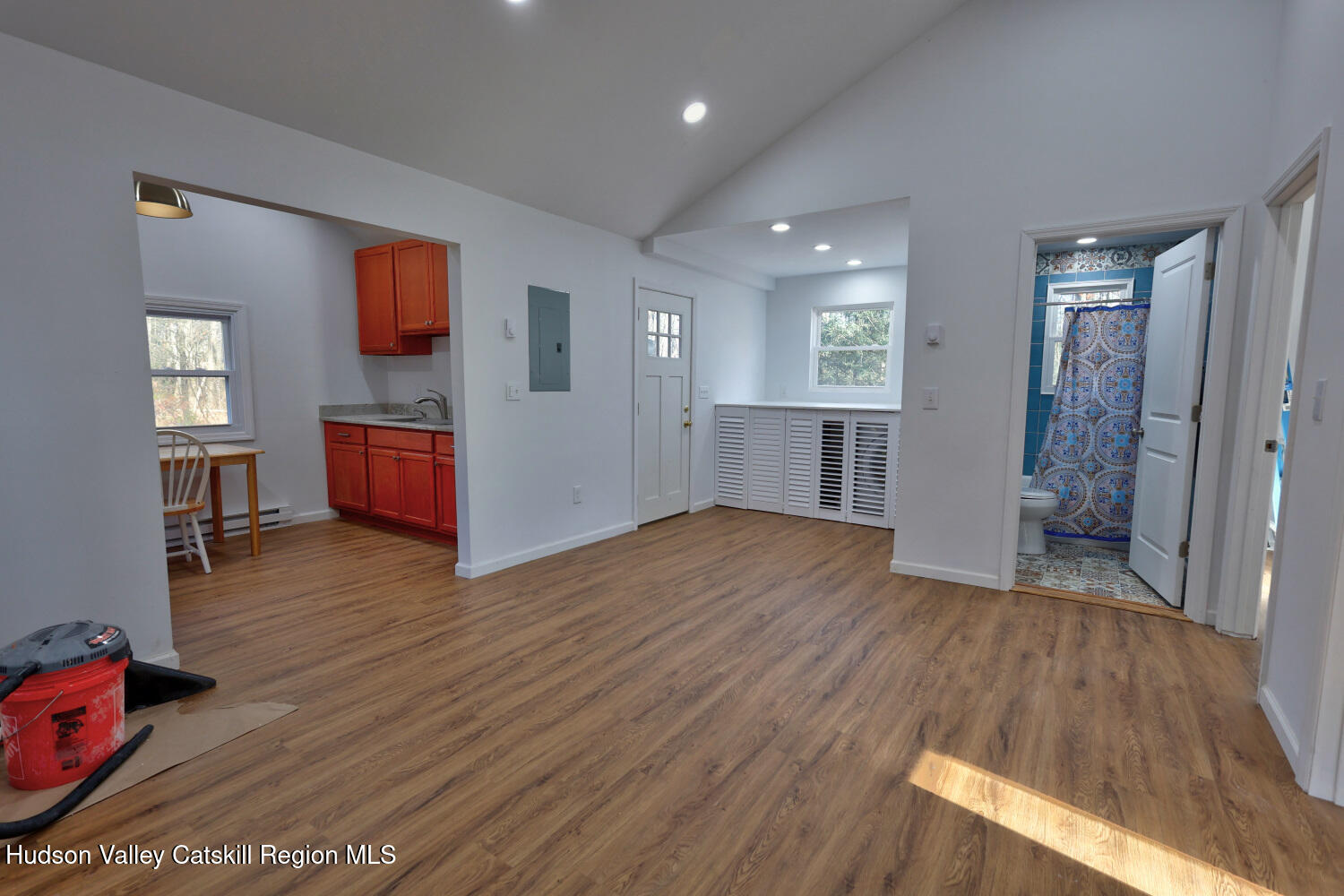 40 Cemetery Road Palenville, NY 12463 - Photo 12 of 47 a view of a kitchen and an empty room with wooden floor and a window