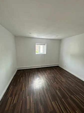a view of an empty room and wooden floor