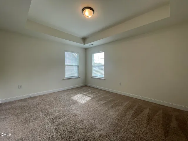 a spacious bathroom with a double vanity sink a toilet and a mirror