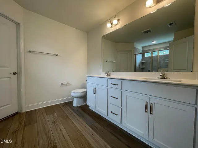 a bathroom with a glass shower door