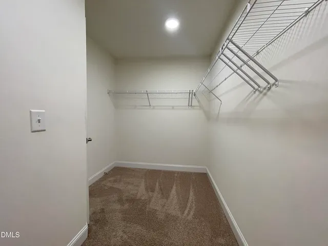 a bedroom with a large bed and a potted plant