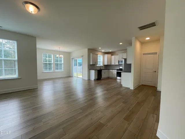 an open kitchen with a table and chairs in it