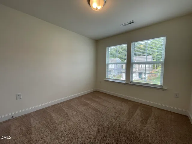 an empty room with window and windows