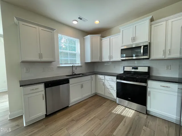 a view of an empty room with glass door and balcony