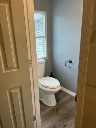 a white toilet sitting next to a sink