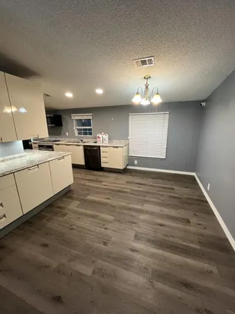 a large kitchen with kitchen island a sink stainless steel appliances and cabinets