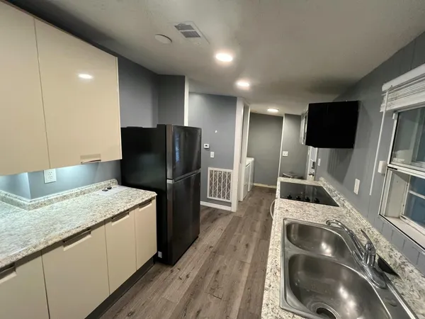 a kitchen with a sink a refrigerator and washer