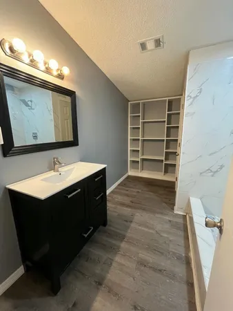 a room with a sink and a mirror