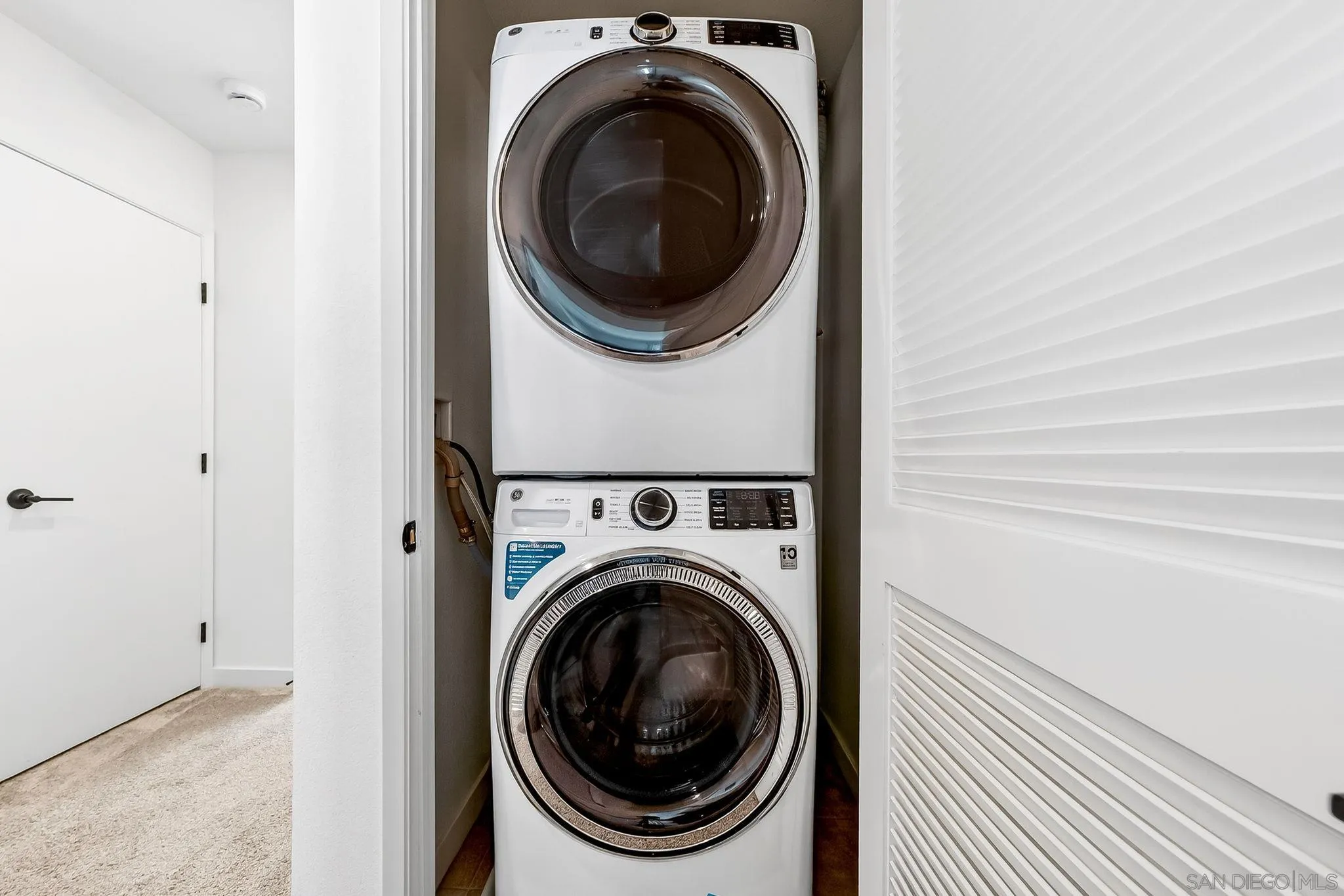 307 Seedling Way Fallbrook, CA 92028 - Photo 13 of 20 a view of a hallway with washer and dryer