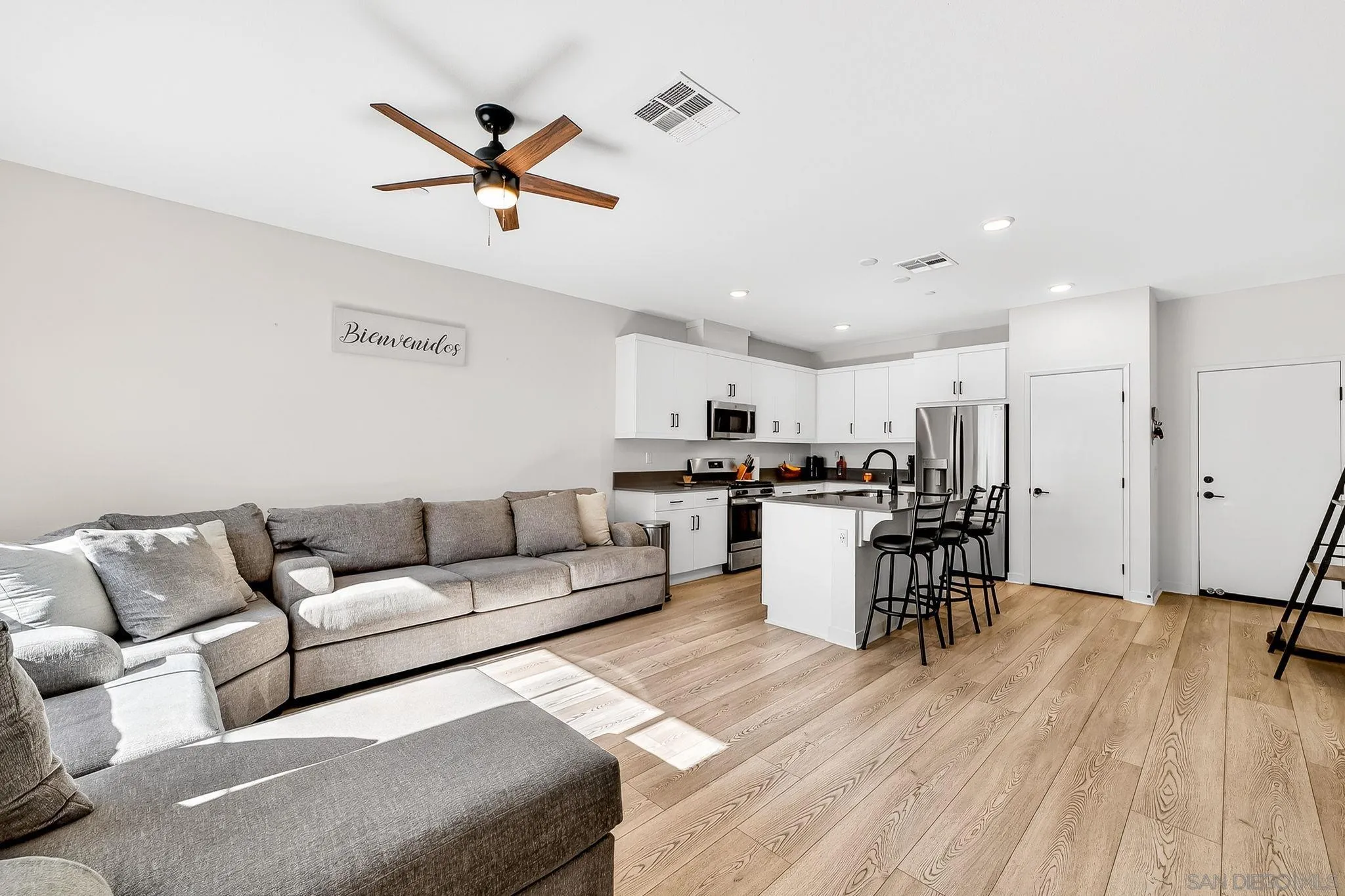 307 Seedling Way Fallbrook, CA 92028 - Photo 4 of 20 a living room with furniture kitchen view and a wooden floor