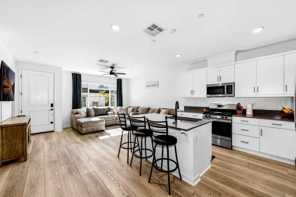 a kitchen with stainless steel appliances a sink stove and cabinets