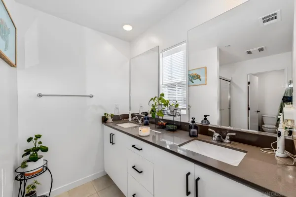 a bathroom with a granite countertop sink mirror toilet and bathtub