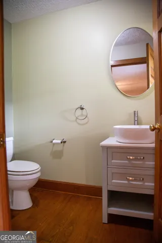 a bathroom with a toilet a sink and mirror