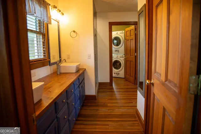 a bathroom with a granite countertop shower and a sink