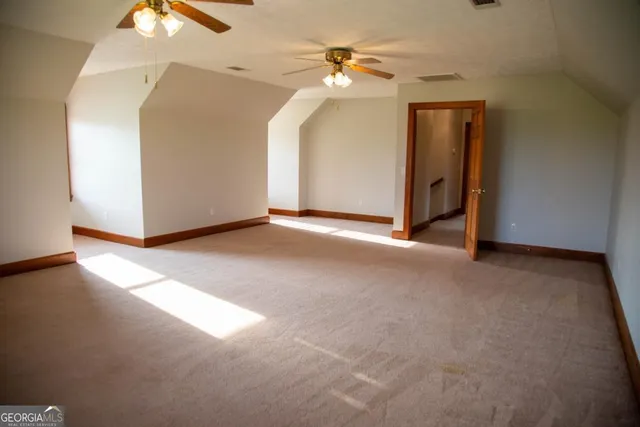 a view of a big room with closet and a chandelier fan