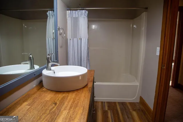 a bathroom with a tub and shower