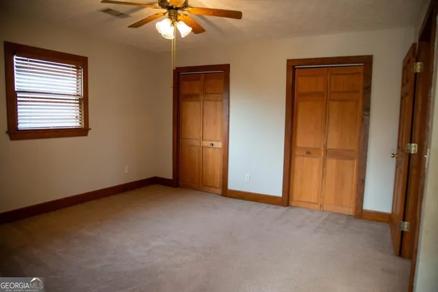 an empty room with window and closet