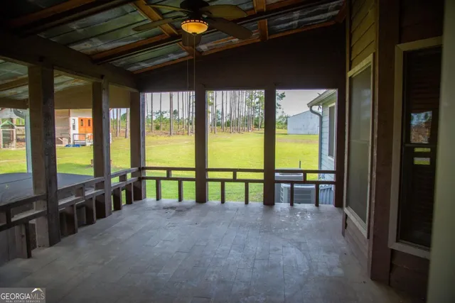 a view of an empty room with windows