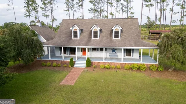 a front view of a house with a yard table and chairs