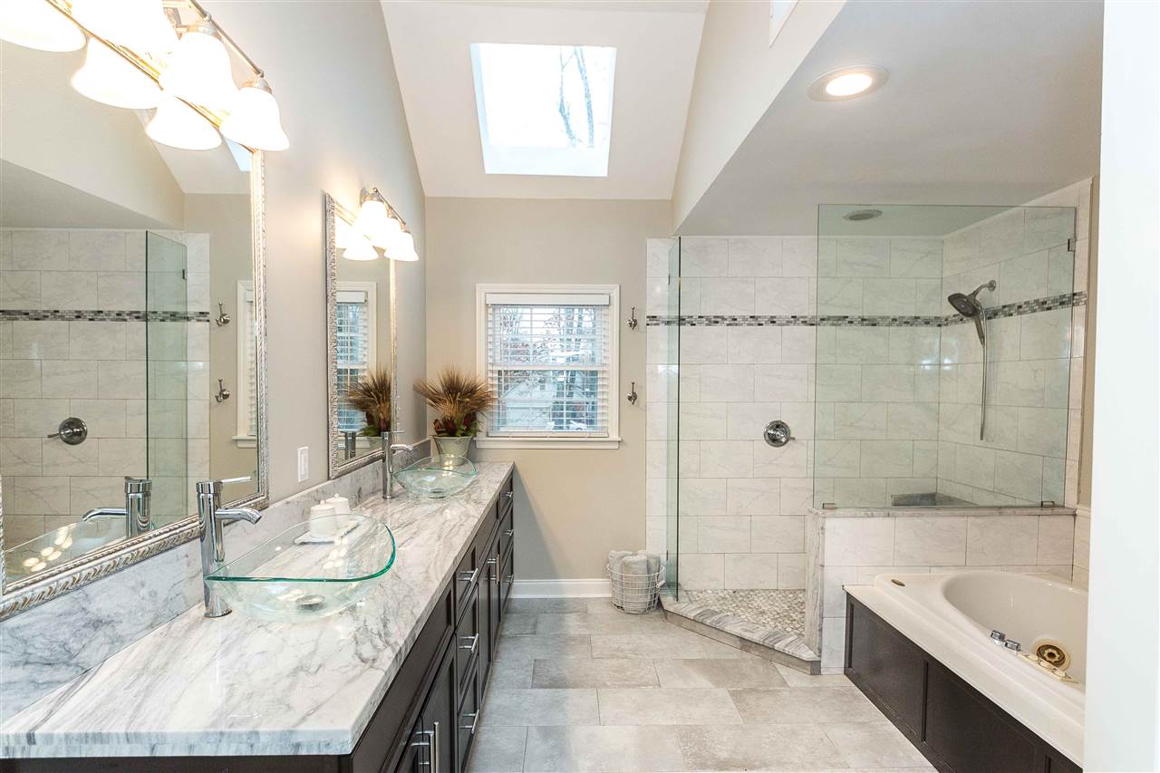 1211 Frank Road Collierville, TN 38017 - Photo 12 of 23 This beautifully renovated master bath has a separate shower, two vanities, toliet room and a jacuzzi.