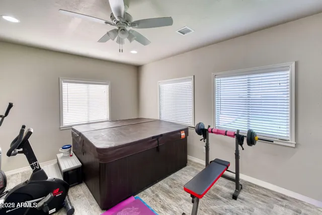 a bathroom with a granite countertop sink a toilet a mirror and shower