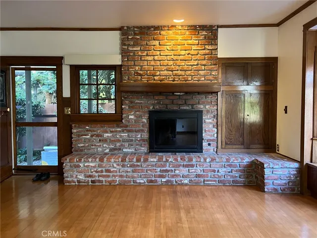 a living room with fireplace furniture and a wooden floor