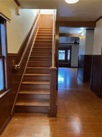 a view of entryway and hall with wooden floor