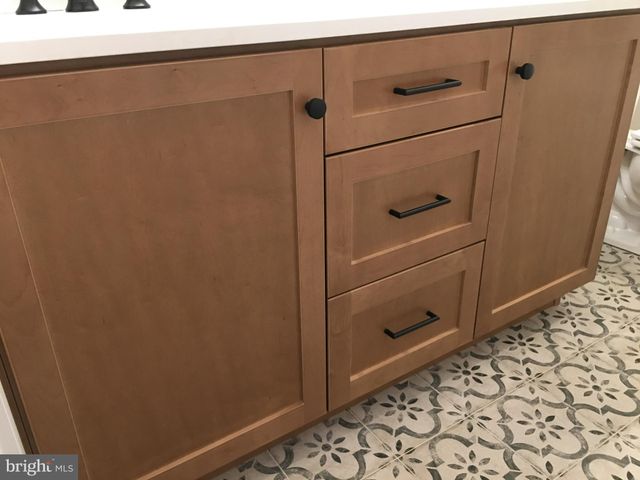 a bathroom with a shower and a sink