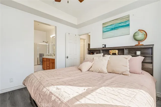 a bedroom with bed and wooden floor