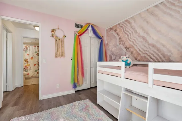 a view of a bedroom with a bed and a window