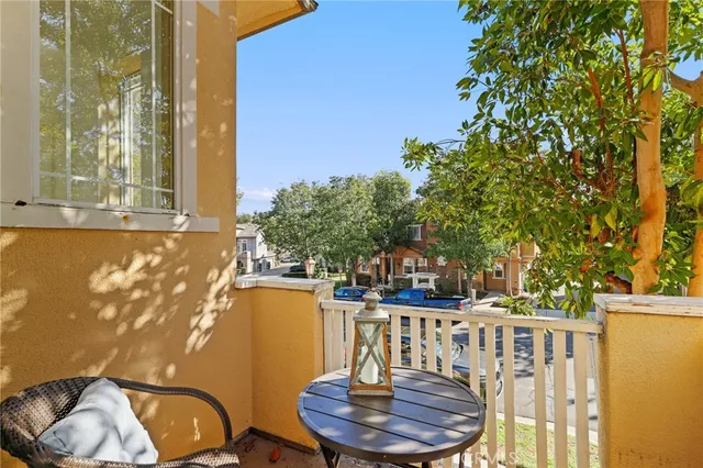 a balcony with table and chairs