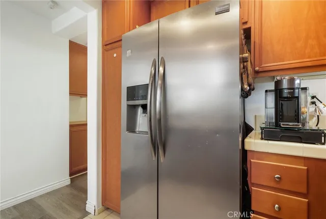 a kitchen with a refrigerator and cabinets