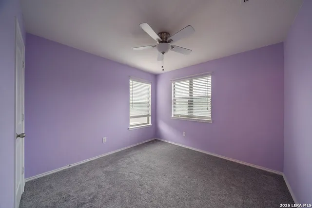 a view of a livingroom with a ceiling fan and window