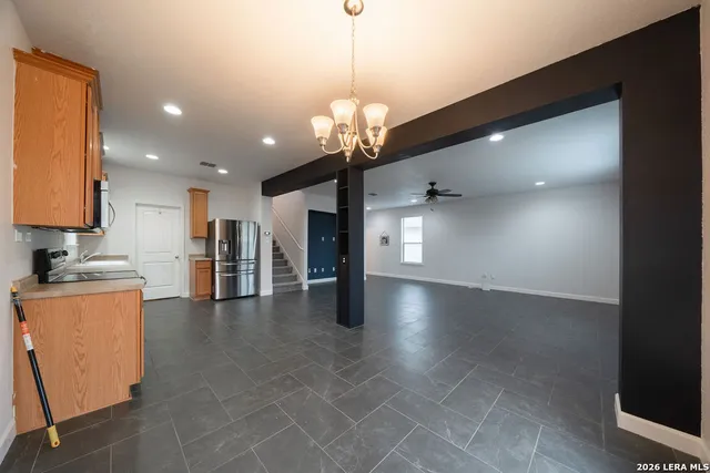 a view of a kitchen with a sink and a chandelier