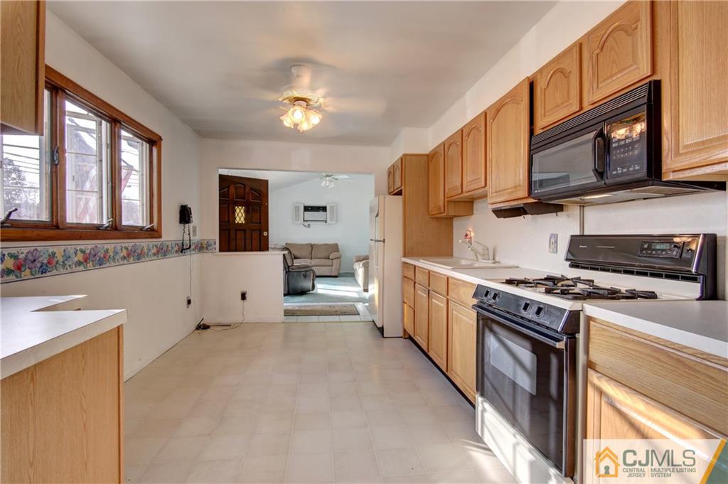 38 Tunison Road New Brunswick, NJ 08901 - Photo 4 of 18 a kitchen with stainless steel appliances granite countertop a stove and a sink