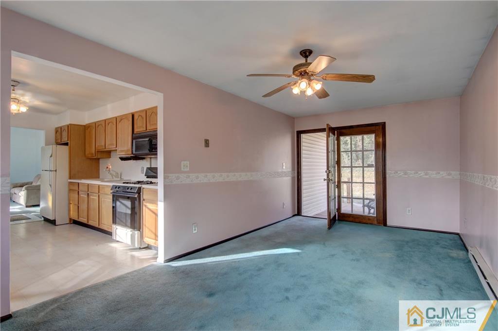 38 Tunison Road New Brunswick, NJ 08901 - Photo 7 of 18 a view of a kitchen with furniture and a ceiling fan