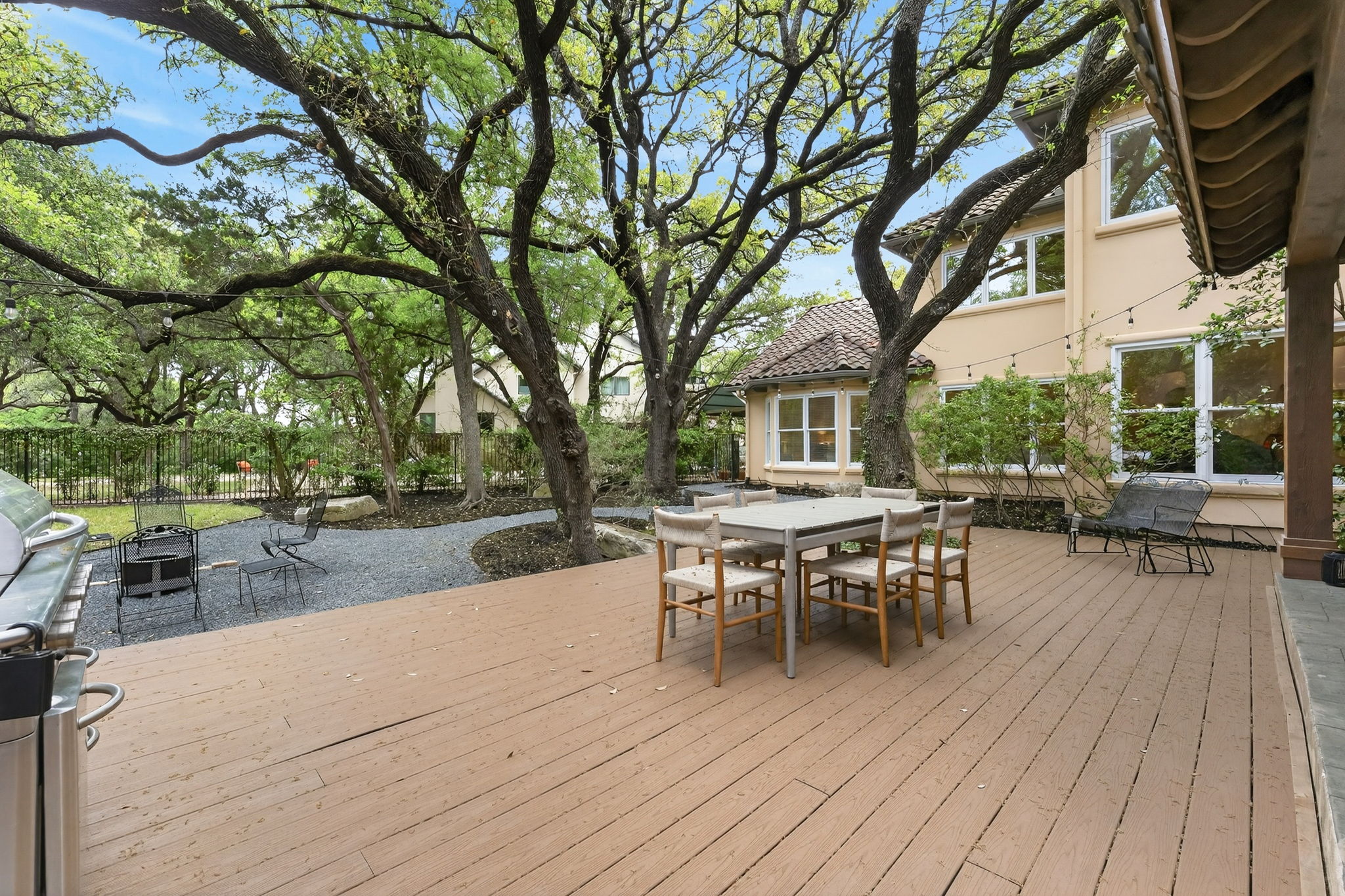 4110 Bunny Run, Unit 3 Austin, TX 78746 - Photo 30 of 35 An expansive outdoor deck offers ample space for entertaining, complemented by a gravel patio area